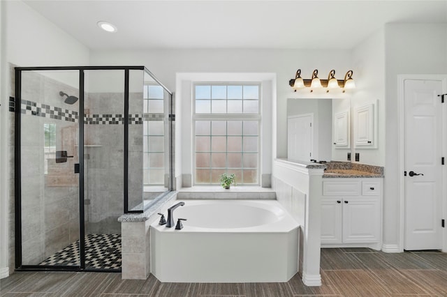 5413 Percy Priest St, Fort Worth, TX 76179 - bathroom with a bath, a shower stall, vanity, and wood tiled floors
