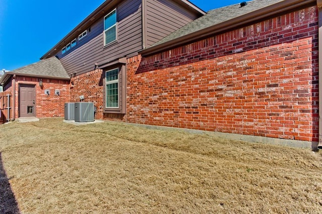 5413 Percy Priest St, Fort Worth, TX 76179 - rear view of property featuring brick siding, a yard, and roof with shingles