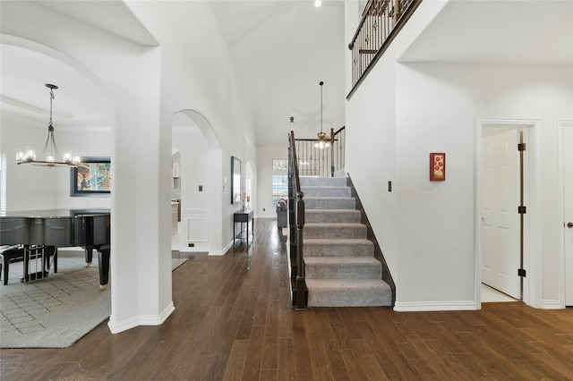 5413 Percy Priest St, Fort Worth, TX 76179 - entryway with a chandelier, arched walkways, dark wood-style floors, and stairs