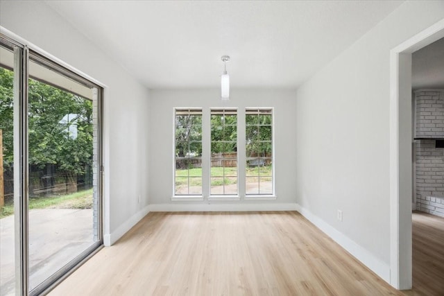 4132 Alava Dr, Fort Worth, TX 76133 - spare room with light wood-type flooring and a brick fireplace
