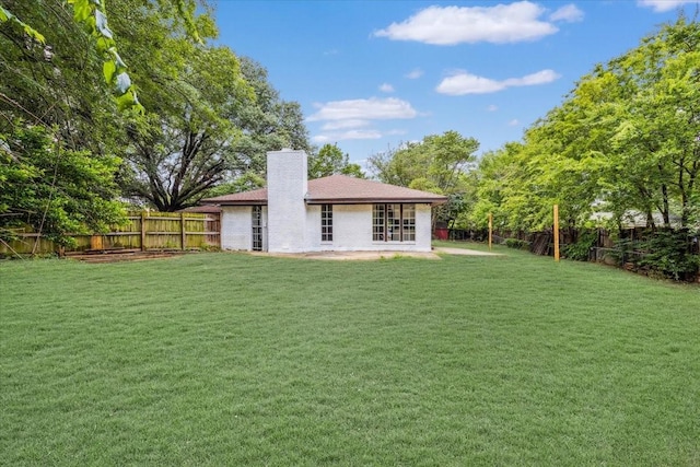 4132 Alava Dr, Fort Worth, TX 76133 - back of property featuring a chimney, a fenced backyard, and brick siding