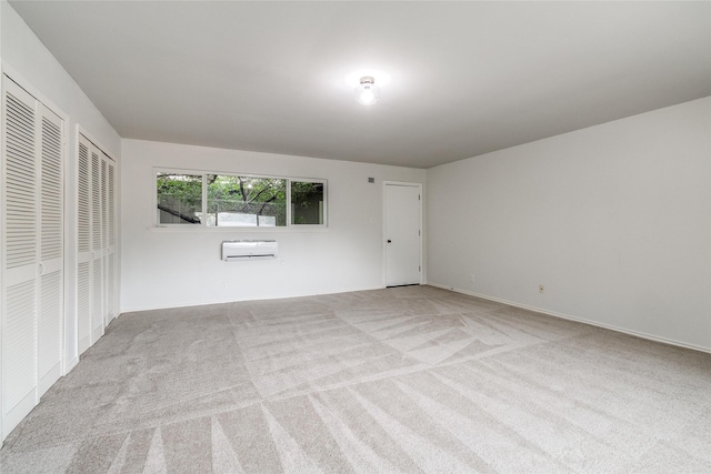 9707 Highland View Dr, Dallas, TX 75238 - carpeted empty room featuring a wall mounted air conditioner