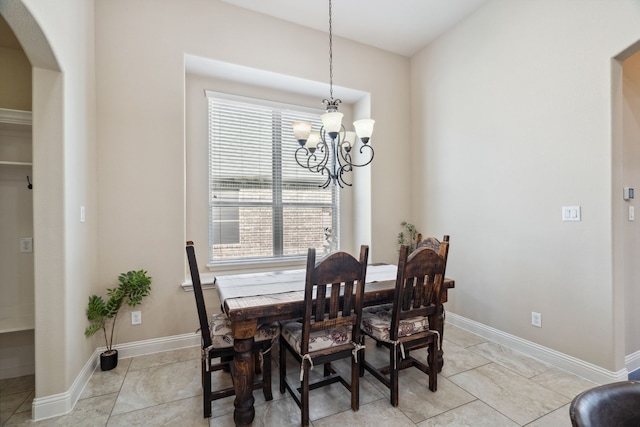 1256 Teton Dr, Burleson, TX 76028 - dining area with a chandelier, arched walkways, healthy amount of natural light, and light tile patterned flooring