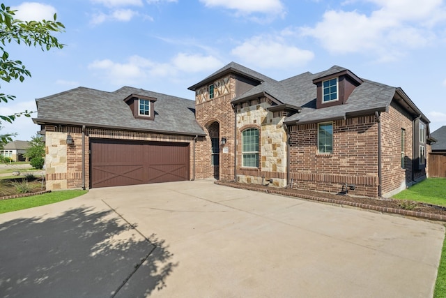 1256 Teton Dr, Burleson, TX 76028 - french provincial home with concrete driveway, brick siding, an attached garage, roof with shingles, and stone siding