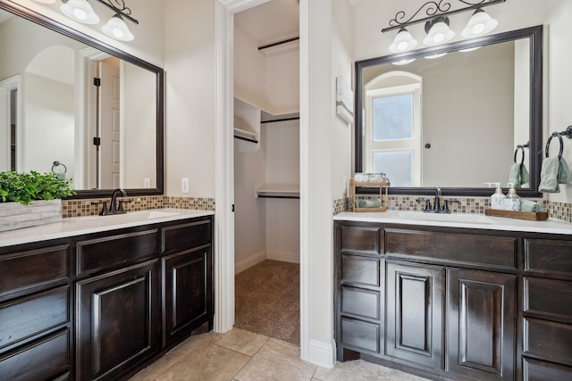 1256 Teton Dr, Burleson, TX 76028 - bathroom featuring vanity, a walk in closet, tasteful backsplash, and tile patterned floors
