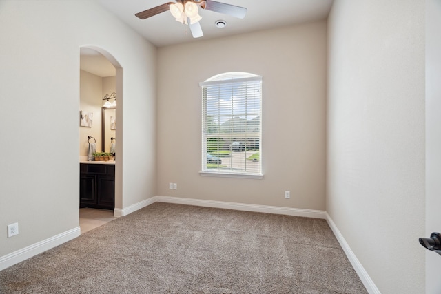 1256 Teton Dr, Burleson, TX 76028 - spare room featuring light colored carpet, ceiling fan, and arched walkways