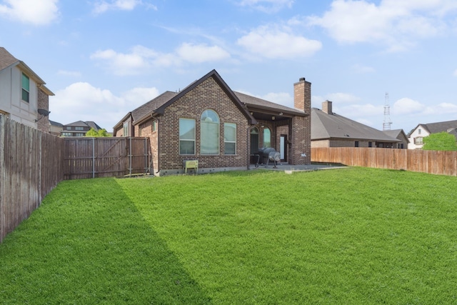 1256 Teton Dr, Burleson, TX 76028 - rear view of property featuring brick siding, a chimney, and a fenced backyard