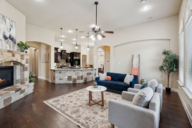 1256 Teton Dr, Burleson, TX 76028 - living room with arched walkways, ceiling fan, dark wood-style flooring, a fireplace, and recessed lighting
