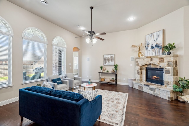 1256 Teton Dr, Burleson, TX 76028 - living room featuring dark wood-type flooring, a fireplace, arched walkways, recessed lighting, and ceiling fan