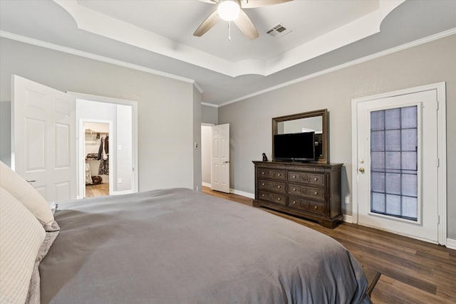 1005 Prairie Ln, Mcgregor, TX 76657 - bedroom with a tray ceiling, wood finished floors, crown molding, and a ceiling fan