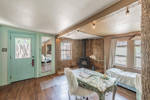 2057 Breezywood Dr, Flower Mound, TX 75022 - dining room featuring a textured ceiling, a wood stove, and wood finished floors