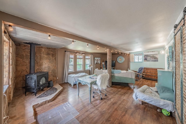 2057 Breezywood Dr, Flower Mound, TX 75022 - bedroom with wood finished floors and a wood stove