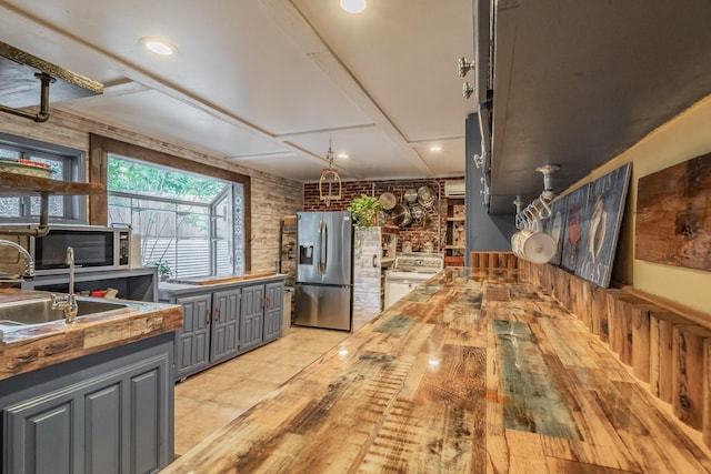 2057 Breezywood Dr, Flower Mound, TX 75022 - kitchen with appliances with stainless steel finishes, butcher block countertops, gray cabinets, light wood-style flooring, and recessed lighting
