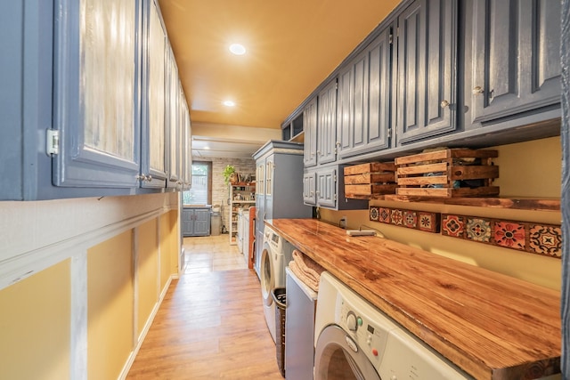 2057 Breezywood Dr, Flower Mound, TX 75022 - laundry room with washing machine and clothes dryer, light wood-style floors, and recessed lighting