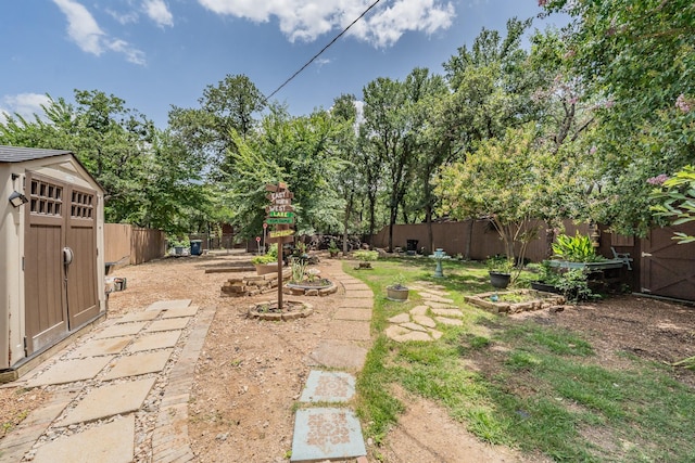 2057 Breezywood Dr, Flower Mound, TX 75022 - fenced backyard with a vegetable garden, a storage shed, and view of wooded area