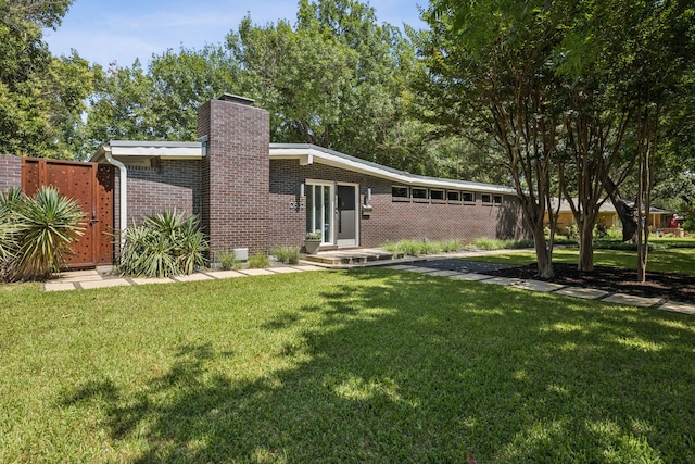 10832 Cinderella Ln, Dallas, TX 75229 - view of front facade with a chimney and brick siding