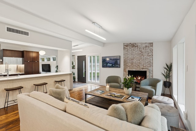 10832 Cinderella Ln, Dallas, TX 75229 - living area featuring dark wood-style floors and a fireplace