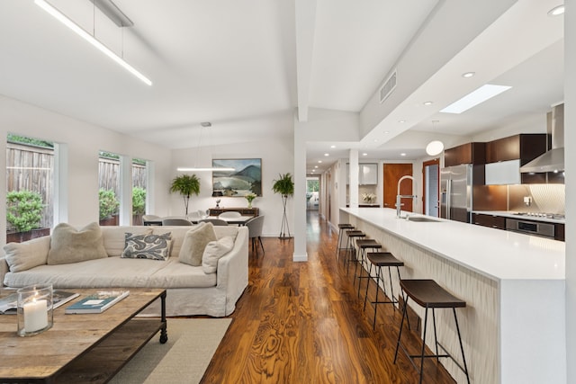 10832 Cinderella Ln, Dallas, TX 75229 - living area featuring dark wood-type flooring, a skylight, recessed lighting, and beamed ceiling