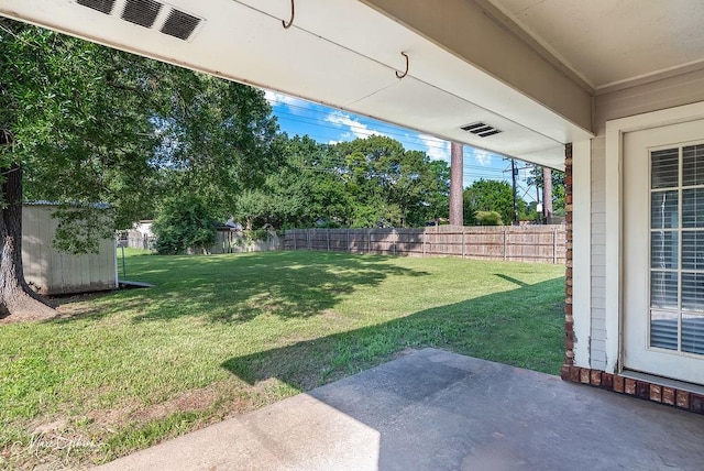 9440 Castlebrook Dr, Shreveport, LA 71129 - fenced backyard with a patio area and a storage unit