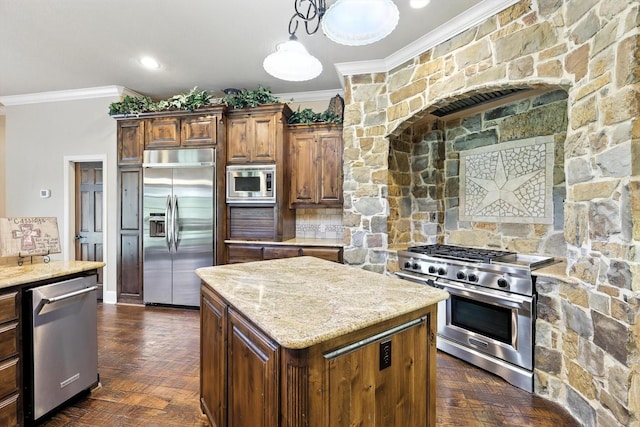 12780 Cartwright Trl, Ponder, TX 76259 - kitchen featuring built in appliances, crown molding, light stone countertops, a center island, and decorative light fixtures