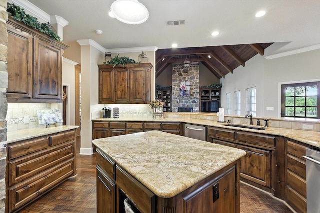 12780 Cartwright Trl, Ponder, TX 76259 - kitchen featuring dark wood-type flooring, decorative backsplash, light stone counters, a kitchen island, and dishwasher