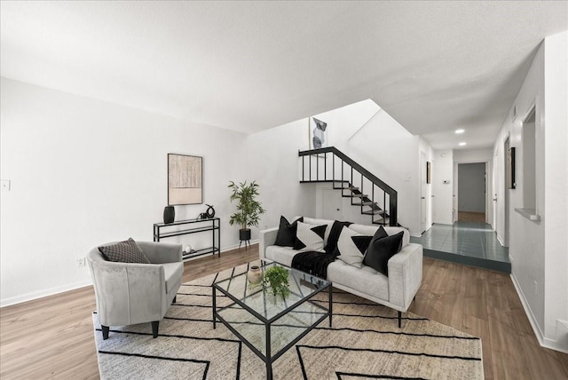 9206 Flickering Shadow Dr, Dallas, TX 75243 - living room with stairway, wood finished floors, and recessed lighting