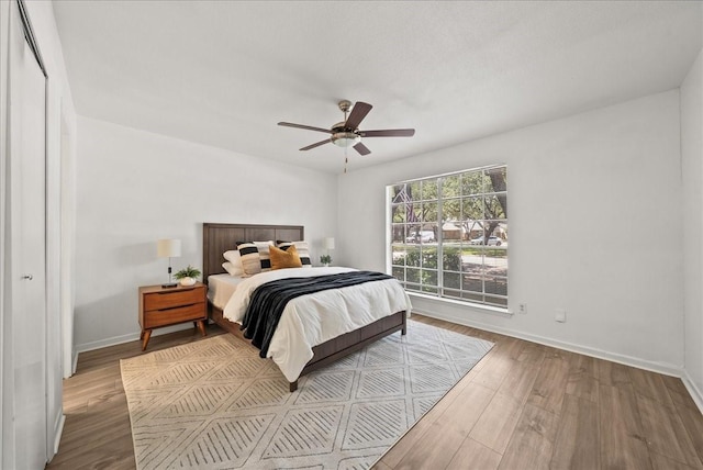 9206 Flickering Shadow Dr, Dallas, TX 75243 - bedroom with wood finished floors and ceiling fan