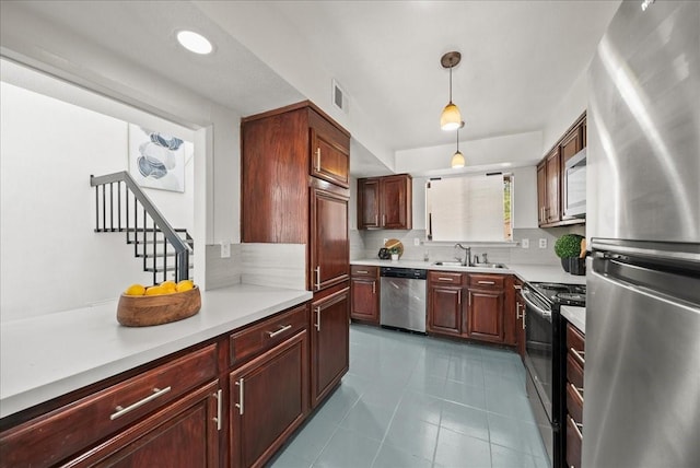 9206 Flickering Shadow Dr, Dallas, TX 75243 - kitchen featuring stainless steel appliances, light countertops, hanging light fixtures, dark tile patterned floors, and recessed lighting