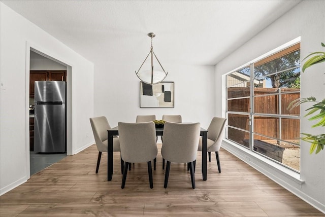 9206 Flickering Shadow Dr, Dallas, TX 75243 - dining room with light wood-style floors and baseboards