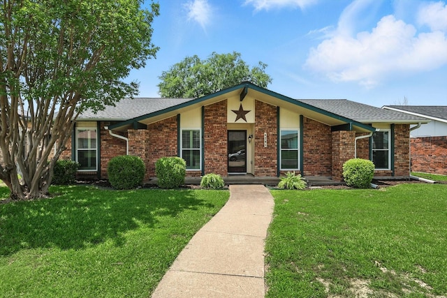 4201 Blackwillow Dr, Mesquite, TX 75150 - view of front of property featuring a front yard, brick siding, and a shingled roof