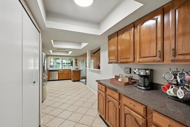 4201 Blackwillow Dr, Mesquite, TX 75150 - kitchen with appliances with stainless steel finishes, brown cabinetry, and light tile patterned floors