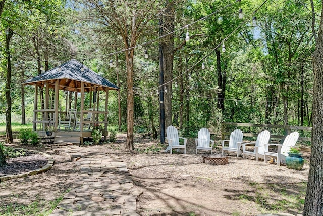 730 Cedar Crk, Reno, TX 75462 - view of patio / terrace with an outdoor fire pit, a gazebo, and a wooded view