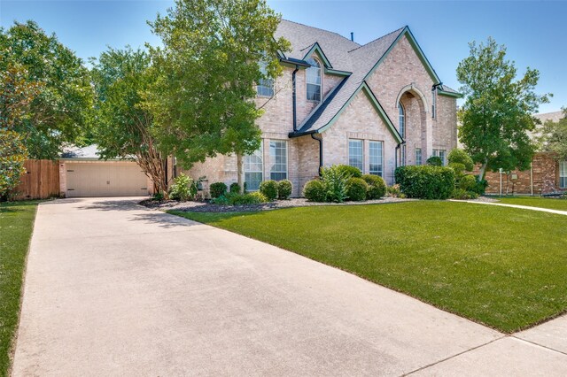 214 Chisholm Trl, Argyle, TX 76226 - view of front facade with brick siding, concrete driveway, and roof with shingles