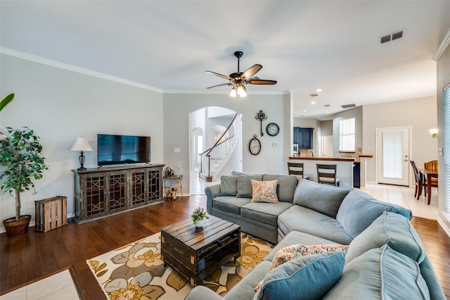 214 Chisholm Trl, Argyle, TX 76226 - living area featuring arched walkways, stairs, ornamental molding, wood finished floors, and a ceiling fan