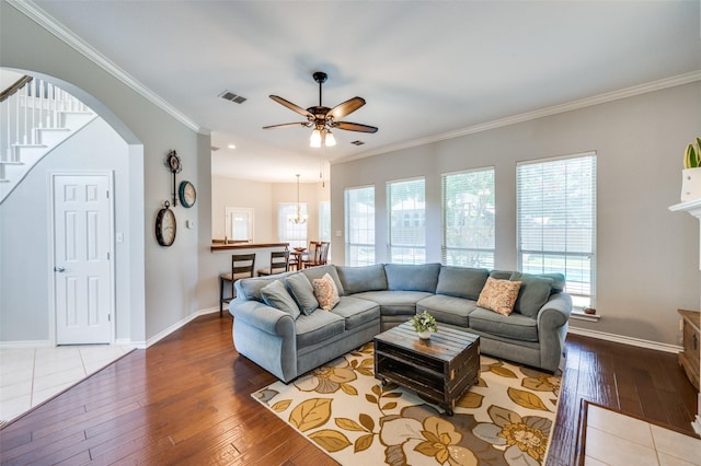 214 Chisholm Trl, Argyle, TX 76226 - living area with ornamental molding, a ceiling fan, hardwood / wood-style floors, arched walkways, and stairs
