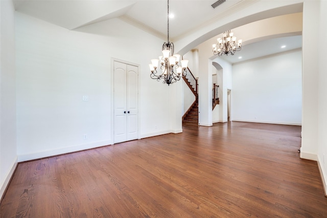 8540 Canyon Xing, Lantana, TX 76226 - empty room featuring arched walkways, a chandelier, ornamental molding, stairs, and wood finished floors