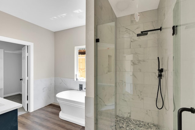 5136 Farnsworth Ave, Fort Worth, TX 76107 - bathroom featuring a stall shower, a freestanding bath, vanity, wood finished floors, and a wainscoted wall