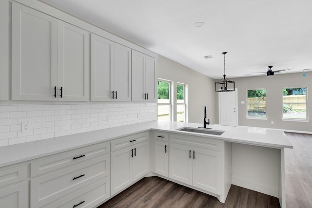 5136 Farnsworth Ave, Fort Worth, TX 76107 - kitchen with a peninsula, backsplash, light countertops, white cabinets, and dark wood finished floors