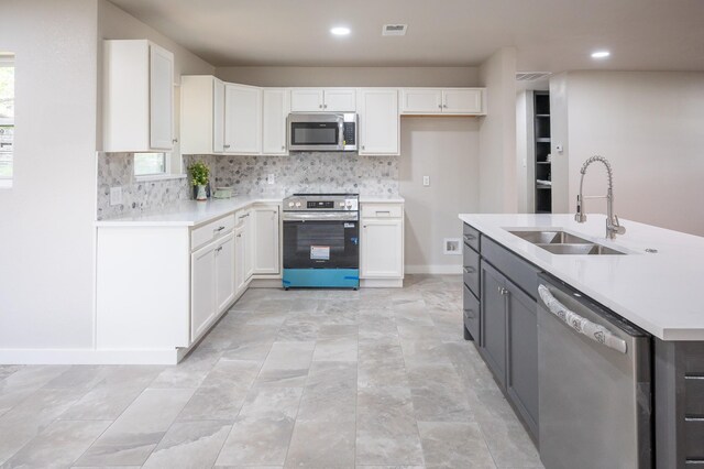820 Vickie Dr, Azle, TX 76020 - kitchen with stainless steel appliances, white cabinetry, light countertops, decorative backsplash, and recessed lighting