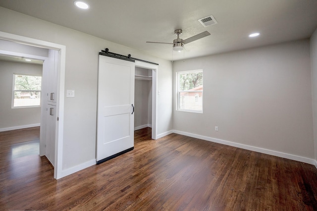 820 Vickie Dr, Azle, TX 76020 - unfurnished bedroom featuring a barn door, dark wood finished floors, a closet, recessed lighting, and ceiling fan