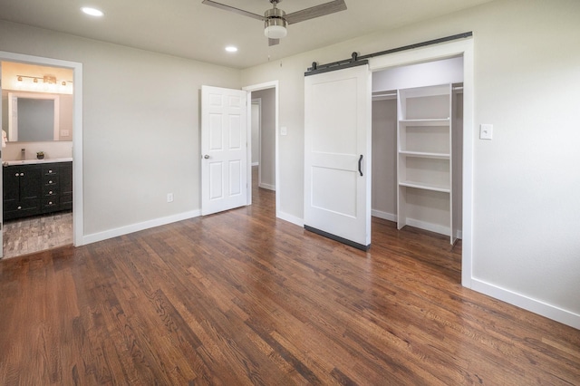 820 Vickie Dr, Azle, TX 76020 - unfurnished bedroom with a barn door, wood finished floors, recessed lighting, connected bathroom, and ceiling fan