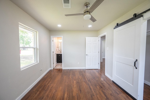 820 Vickie Dr, Azle, TX 76020 - unfurnished bedroom featuring dark wood-type flooring, a barn door, recessed lighting, ceiling fan, and ensuite bathroom