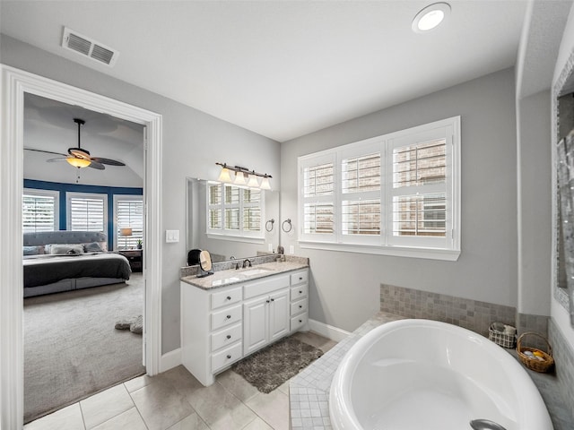 604 Rough Creek Dr, Mckinney, TX 75071 - ensuite bathroom with vanity, a garden tub, a ceiling fan, and tile patterned floors