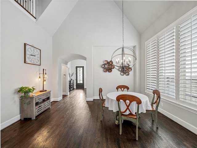 604 Rough Creek Dr, Mckinney, TX 75071 - dining space featuring arched walkways, high vaulted ceiling, dark wood-style floors, and a chandelier