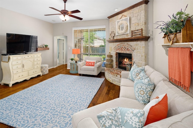 7716 Glenwood Springs Ln, Mckinney, TX 75070 - living room featuring ceiling fan, wood finished floors, and a fireplace