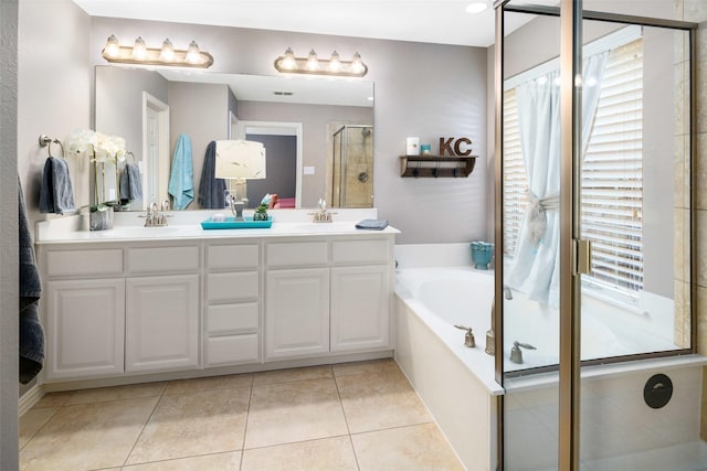 7716 Glenwood Springs Ln, Mckinney, TX 75070 - full bath with healthy amount of natural light, a stall shower, a garden tub, and double vanity