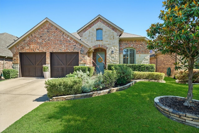 7716 Glenwood Springs Ln, Mckinney, TX 75070 - view of front of house with brick siding, a front lawn, stone siding, an attached garage, and concrete driveway
