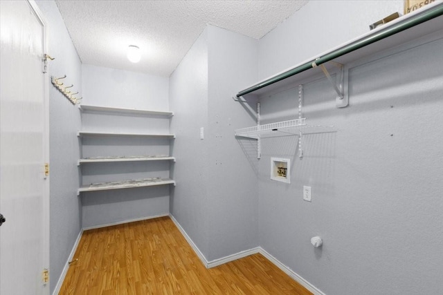 5521 Alta Verde Cir, Arlington, TX 76017 - laundry area with wood finished floors, washer hookup, and a textured ceiling