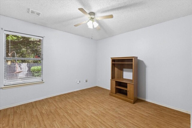 5521 Alta Verde Cir, Arlington, TX 76017 - empty room featuring wood finished floors, a textured ceiling, and ceiling fan