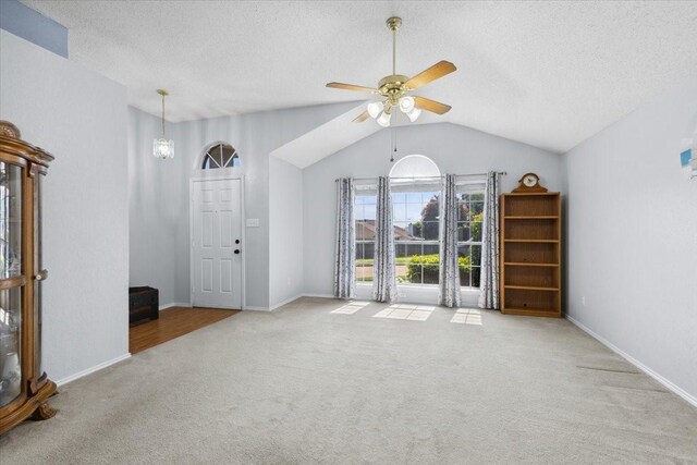 5521 Alta Verde Cir, Arlington, TX 76017 - unfurnished living room with carpet flooring, a ceiling fan, lofted ceiling, and a textured ceiling